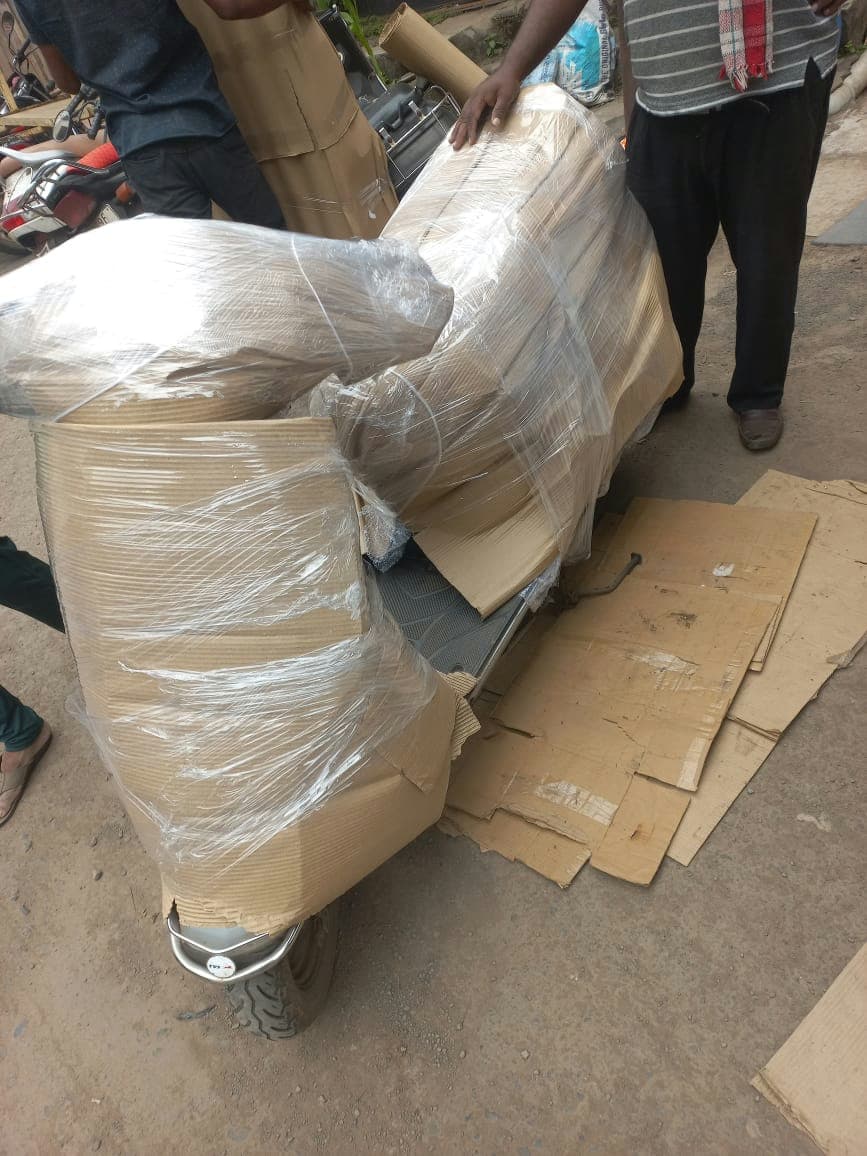 A securely packed scooter being carefully loaded onto a transport vehicle by our expert team.