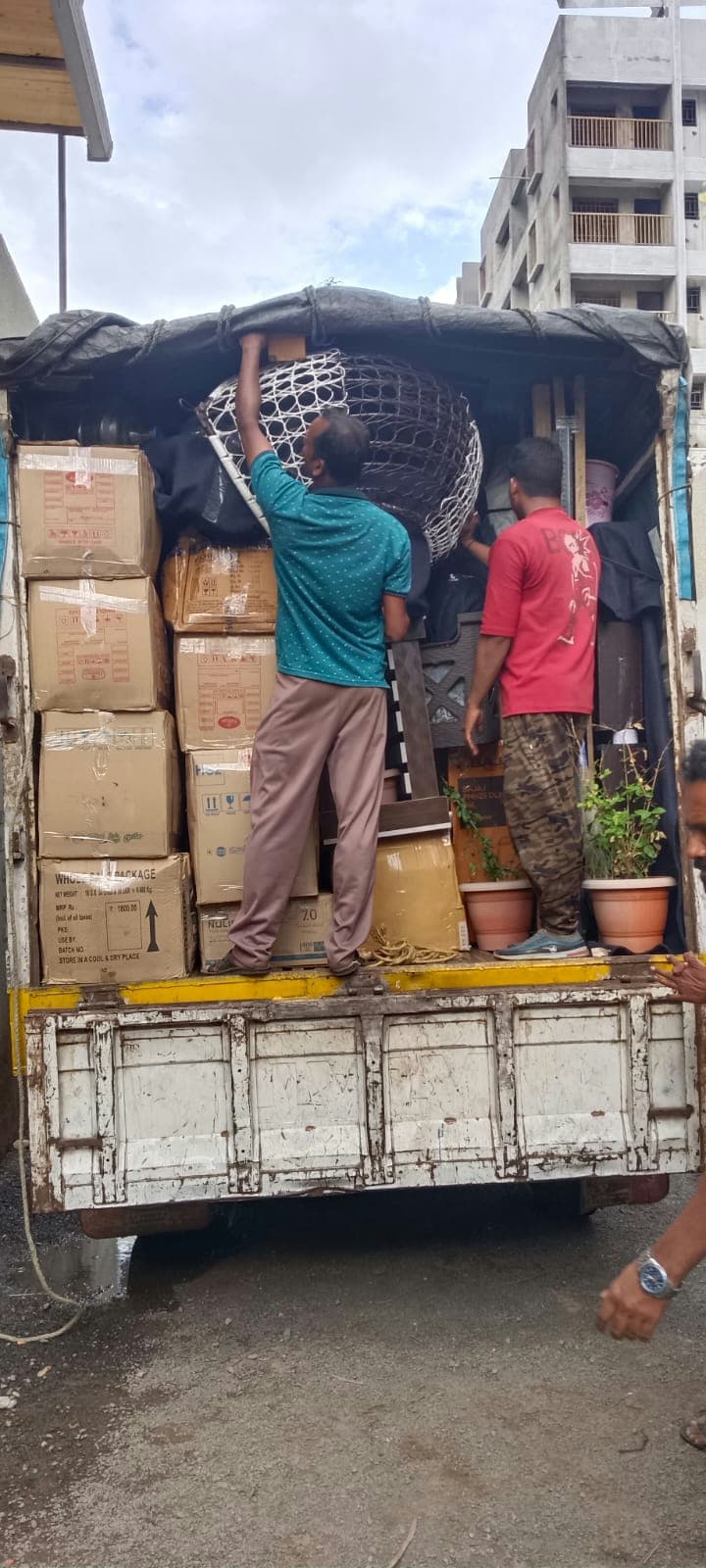 Our professional moving crew expertly stacking and securing household goods in a transport truck.