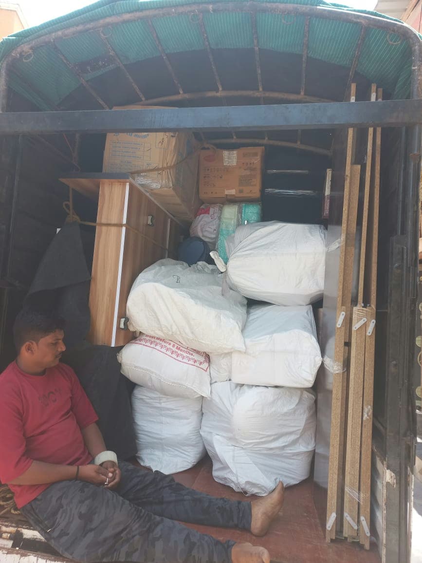 A moving truck filled with carefully packed and organized household goods for a secure journey.
