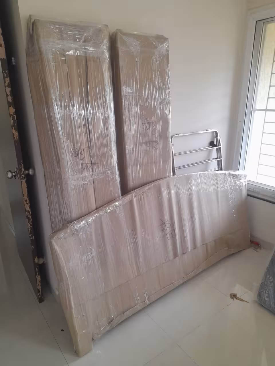 Dismantled and securely wrapped furniture ready for safe transport.