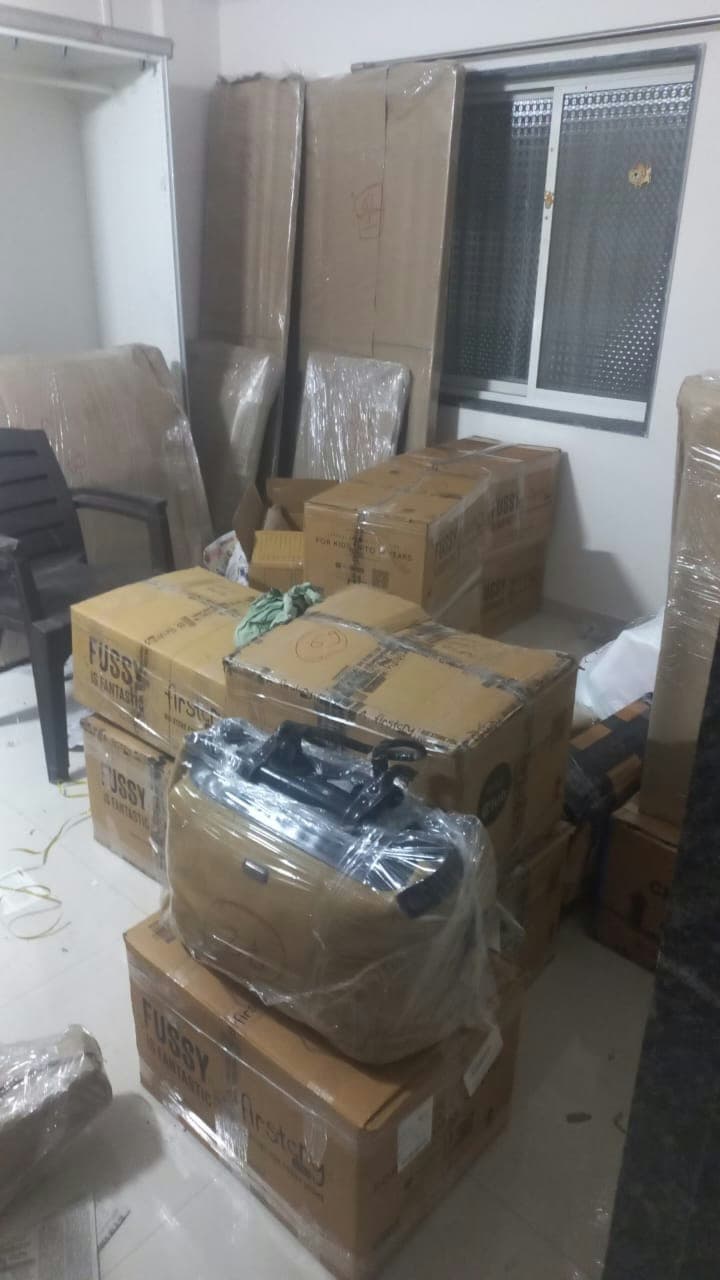 A room full of professionally packed furniture and boxes, showcasing our comprehensive home moving service.