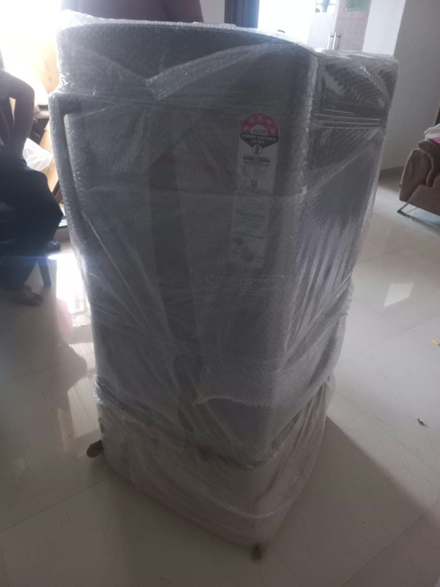 Protective bubble wrapping for a large appliance like a washing machine to guard against dents and scratches.