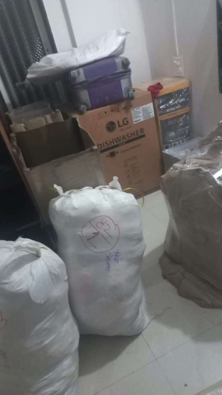 Efficiently packed household goods, utilizing original appliance boxes, sturdy sacks, and secure wrapping.