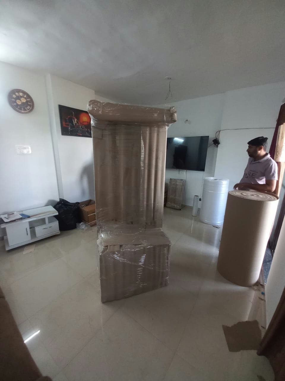 Custom, multi-layer wrapping for a tall, ornate piece of furniture, ensuring every detail is protected.