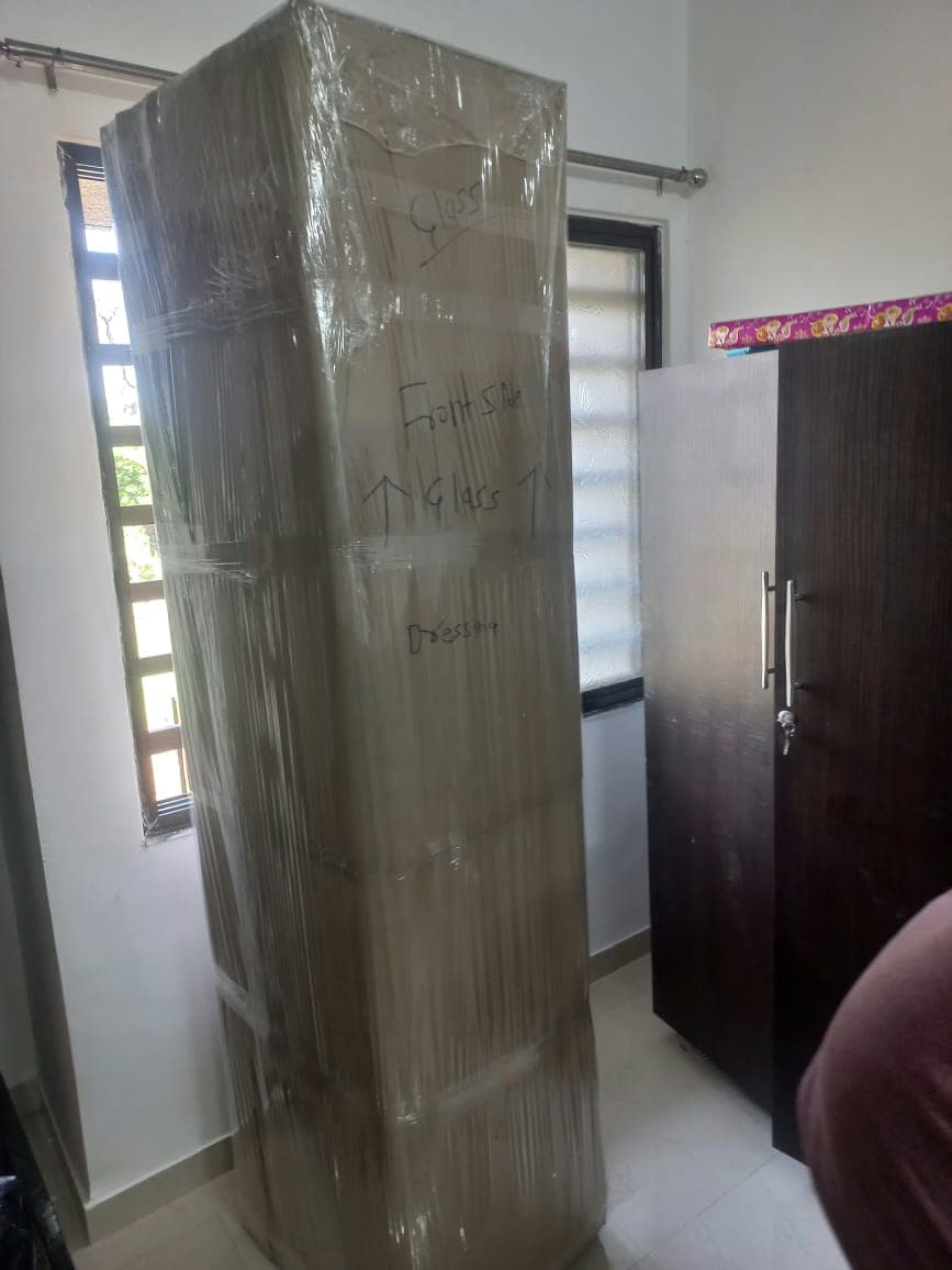 Securely wrapped dressing table, clearly labeled with handling instructions like 'Glass' for safe transport.