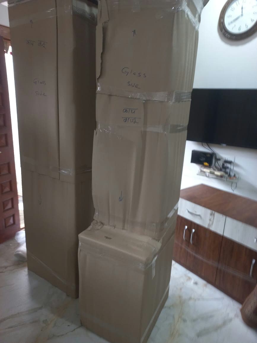 Large furniture items like dressers securely wrapped in cardboard and clearly labeled for fragile handling.