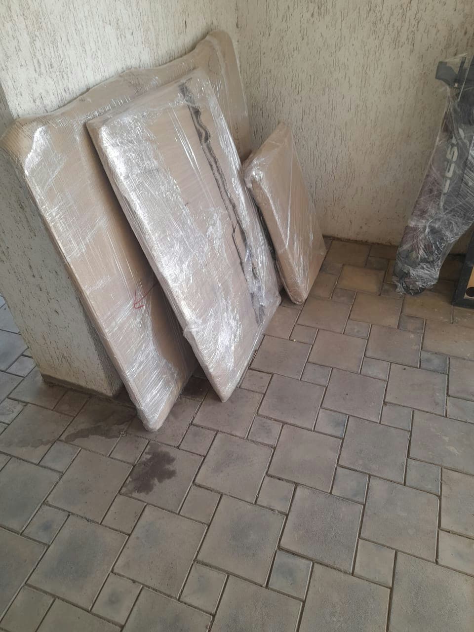 Dismantled furniture components, like bed panels, wrapped and ready for efficient loading and transport.
