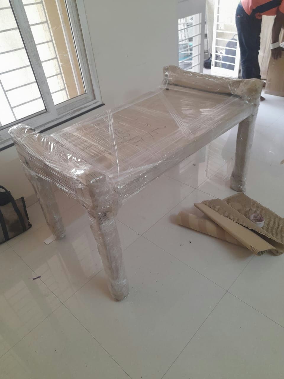 Complete protective wrapping for a wooden diwan, safeguarding all surfaces and legs during transit.