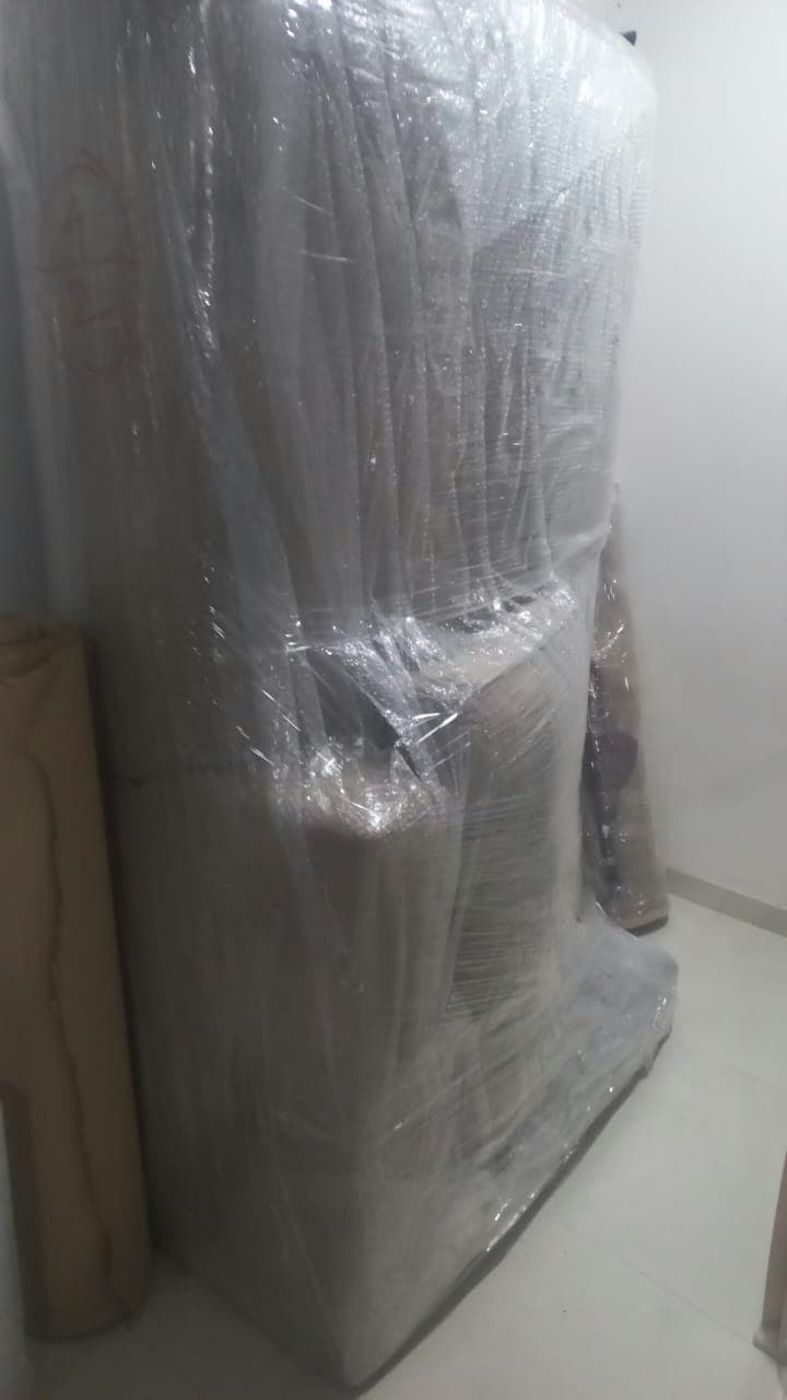 Thoroughly wrapped furniture, completely sealed in protective layers to prevent any damage during transit.