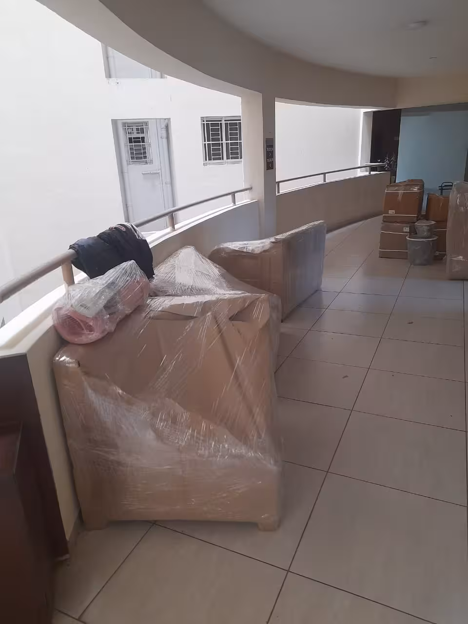 Expertly wrapped furniture and boxes organized for loading and moving.