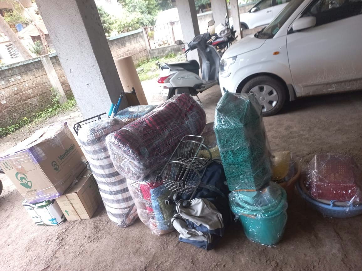 Various household items, including wrapped mattresses and boxes, organized and ready for transport.