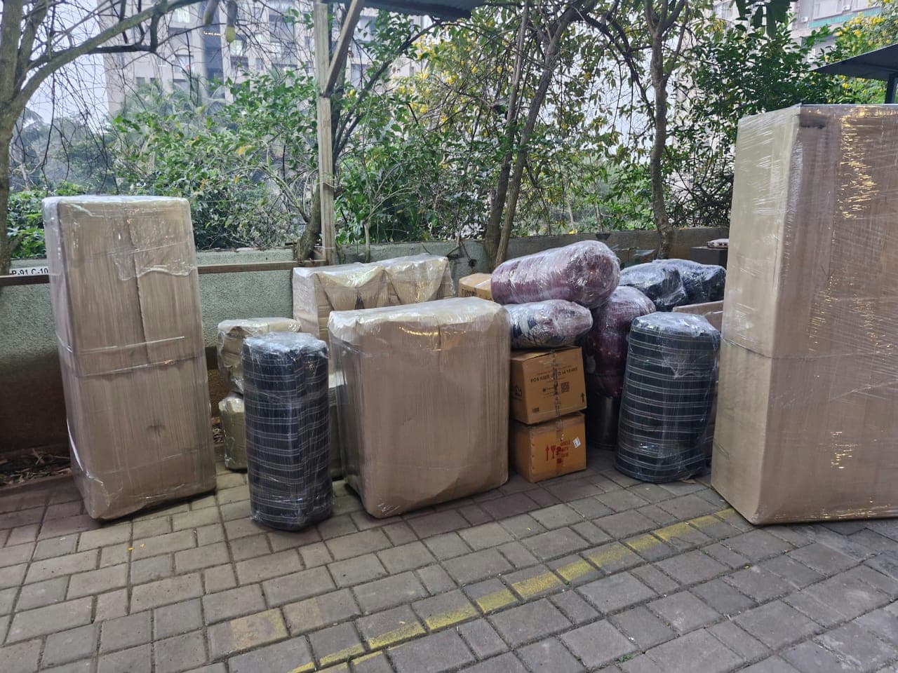 Carefully packed and wrapped household items lined up for a systematic and safe loading process.